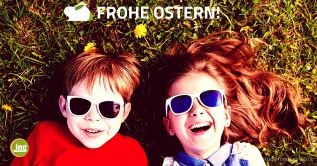 Junge und Mädchen liegen lachend im Gras mit Sonnenbrillen. Zu Ostern geht es um Hasenzähne und wie der Zahnarzt helfen kann - auf Information Mundgesundheit